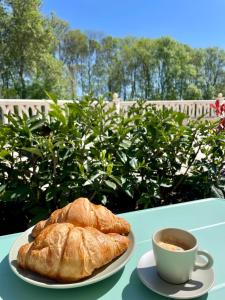 a plate of bread and a cup of coffee on a table at Coral Bay Studio Varna - Beachfront with Free Parking in Varna City