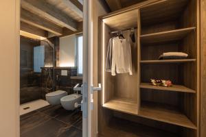 a bathroom with a walk in shower and a toilet at Lillaz Home - Apartments in Cogne +57 photos