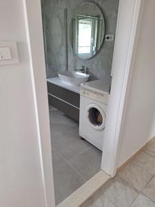 a bathroom with a washing machine and a sink at Zara apartma in Podstrana +8 photos