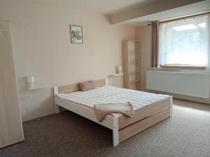 A bed or beds in a room at Penzión Skitour