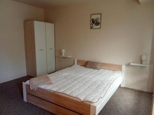 A bed or beds in a room at Penzión Skitour