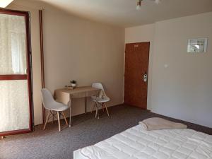 A bed or beds in a room at Penzión Skitour