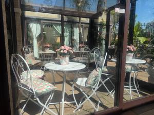a group of tables and chairs with flowers on them at EURO HOUSE INN airport in Fiumicino