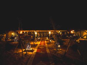 a night view of a building with lights at Sanmao Royal Camp 皇家营地 in Merzouga