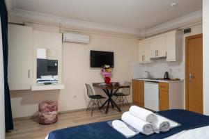 a room with a kitchen and a room with a bed at Taksim Asteria Apart in Istanbul