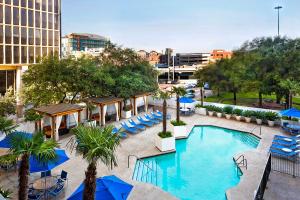 an overhead view of a pool with chairs and umbrellas at The Whitehall Houston in Houston