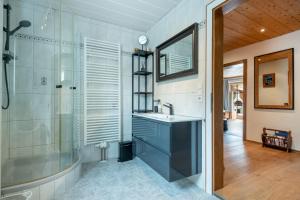 a bathroom with a sink and a shower at Schneehaus Chalet in Ehrwald +31 photos