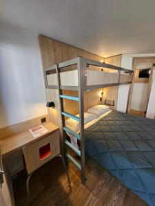 a bedroom with a bunk bed and a desk at Premiere Classe Saint Malo St Jouan Des Guerets in Saint-Jouan-des-Guérets +7 photos