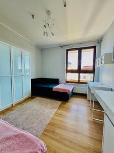 a living room with a couch and a table at Shiraz Park Pogórze in Pogórze +3 photos