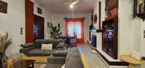 a living room with a couch and a fireplace at Casa Di Marinero Apartments in Argasi