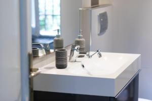 a bathroom with a white sink and a mirror at Da Alessia Per Dormire Al Coppedé in Rome +65 photos