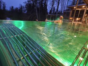 a man sitting in a swimming pool at night at Mysig legenget nära Isaberg in Nissafors