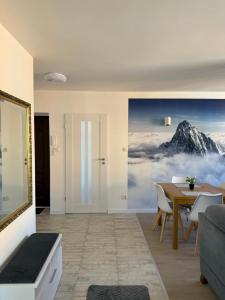 a living room with a mountain mural on the wall at Apartament na Nadrzecznej in Karpacz