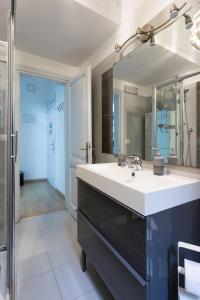 a bathroom with a sink and a mirror at Da Alessia Per Dormire Al Coppedé in Rome