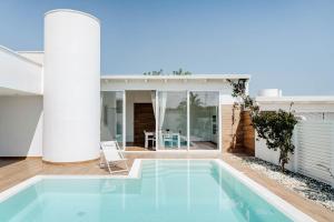 a swimming pool in the middle of a house at Villa Luce Luxury Accomodation in Polignano a Mare