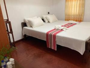 Postel nebo postele na pokoji v ubytování Grand Villa Hikkaduwa