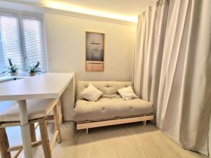 a room with a bench with a table and a curtain at Lecco Antico Pozzo - Modern Suite in Lecco