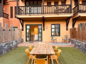 a wooden table and chairs in front of a building at Luna in San Blas in San Miguel de Abona