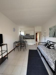 a living room with a bed and a dining room at Cav Casa Brunella in Castiglione della Pescaia