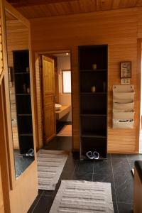 a room with a hallway with a door and shelves at Viesu nams ''Laukezers'' in Vilciņi