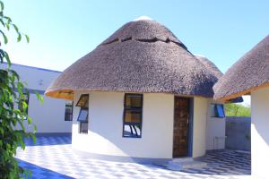 a small house with a thatched roof at Paradise Reho Guesthouse in Nata