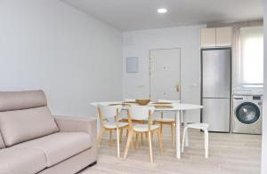 a living room with a couch and a table and chairs at Chalet Ruperto III in Conil de la Frontera