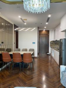 a conference room with a table and chairs and a chandelier at Cozy Homestay Diamond Crown Hải Phòng in Ðông Khê +11 photos