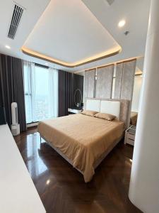 a bedroom with a large bed and a large window at Cozy Homestay Diamond Crown Hải Phòng in Ðông Khê
