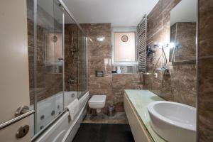 a bathroom with a sink and a tub and a toilet at Taksim Istiklal Street Next2 Hotel in Istanbul +75 photos