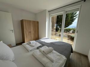 En eller flere senge i et værelse på Isola Bella - Apartment B2