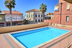 a swimming pool on the roof of a building at Palme in San Vincenzo