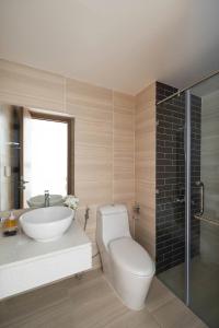 a bathroom with a toilet and a sink and a shower at Otis Soho Saigon Balcony Apartment in Ho Chi Minh City +37 photos
