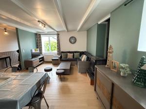 a living room with a couch and a table at Le char a banc - Maison de vacances in Pordic