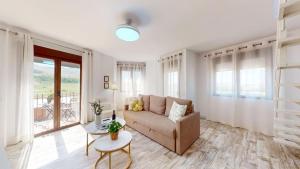 a living room with a couch and a table at Apartamentos Consuegra frente a los molinos in Consuegra