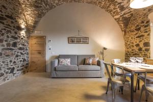 a living room with a couch and a table at Torre di Baratti Bio Resort in Populonia