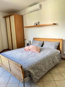 a bedroom with a large bed with a blue comforter at house prua a step from the lake in Bellano