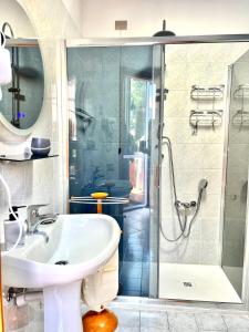 a bathroom with a sink and a shower at house prua a step from the lake in Bellano +50 photos