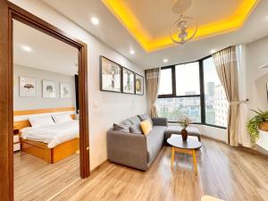 a living room with a couch and a bed at La Maison HUD building 2beds in Nha Trang