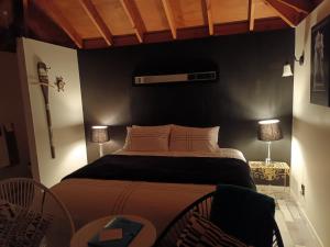 a bedroom with a large bed with a black wall at Blue Stone in Timaru