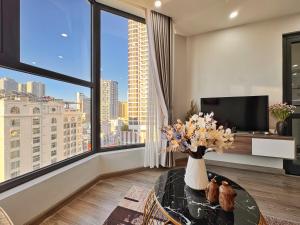 a living room with a vase of flowers on a table at La Maison HUD building 2beds in Nha Trang