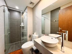 a bathroom with a toilet and a sink and a shower at La Maison HUD building 2beds in Nha Trang +79 photos