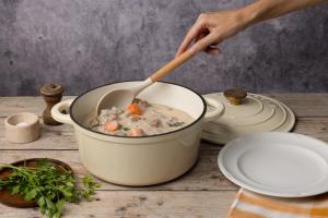 a person stirring a pot of soup with a wooden spoon at Campanile Prime - Aix-en-Provence Sud - Pont de l'Arc in Aix-en-Provence +28 photos