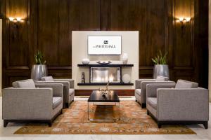 a living room with couches and a fireplace at The Whitehall Houston in Houston