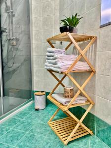 a bamboo towel rack in a bathroom with a shower at house poppa in Bellano