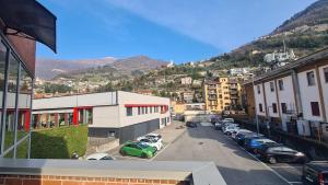 a view of a city with cars parked in a parking lot at house poppa in Bellano