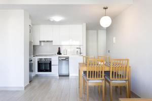 a kitchen with a dining room table and chairs at La Tejita, comfortable one-bedroom apartment in El Médano
