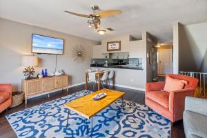 a living room with a table and chairs and a kitchen at Kate's Place - 13554 Perdido Key Drive in Pensacola