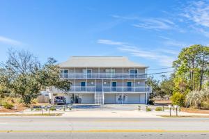 a large house with a car parked in the driveway at Kate's Place - 13554 Perdido Key Drive in Pensacola