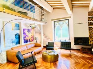 a living room with a couch and a table at La Limonaia della Torretta Luxury Private Pool in Florence