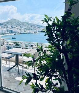 a balcony with a table and a view of the water at Seaside Serenity! FREE PARKING! in Sarandë